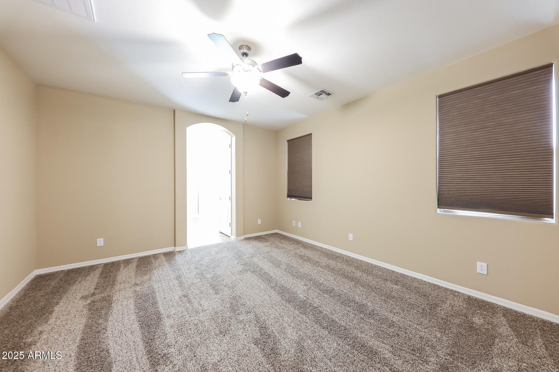 20693 West Ridge Road Buckeye, AZ 85396 - Photo 14 of 16 a view of an empty room with a chandelier fan