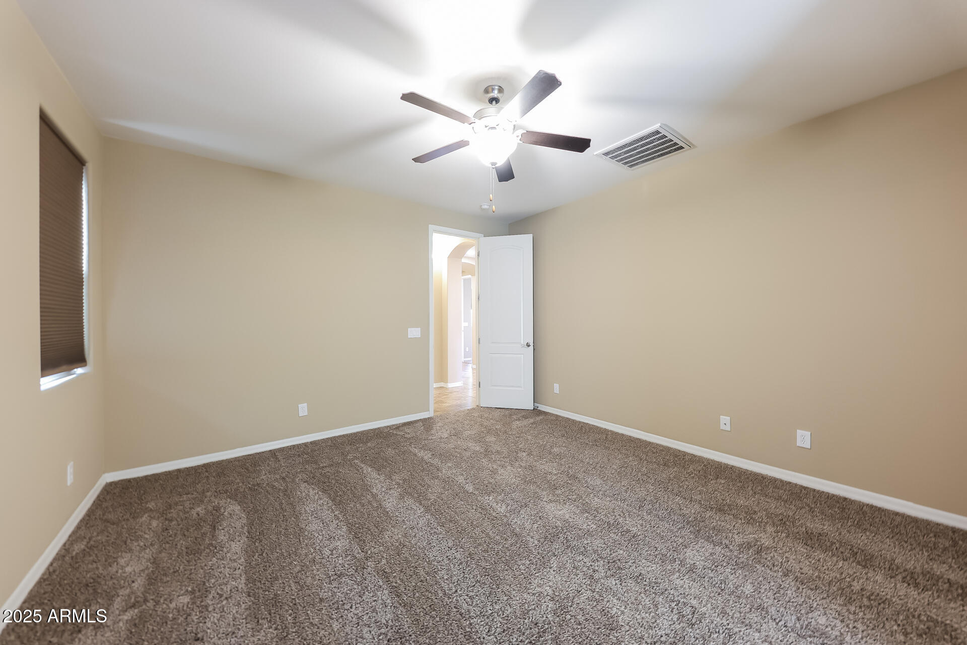 20693 West Ridge Road Buckeye, AZ 85396 - Photo 15 of 16 a view of an empty room with a ceiling fan