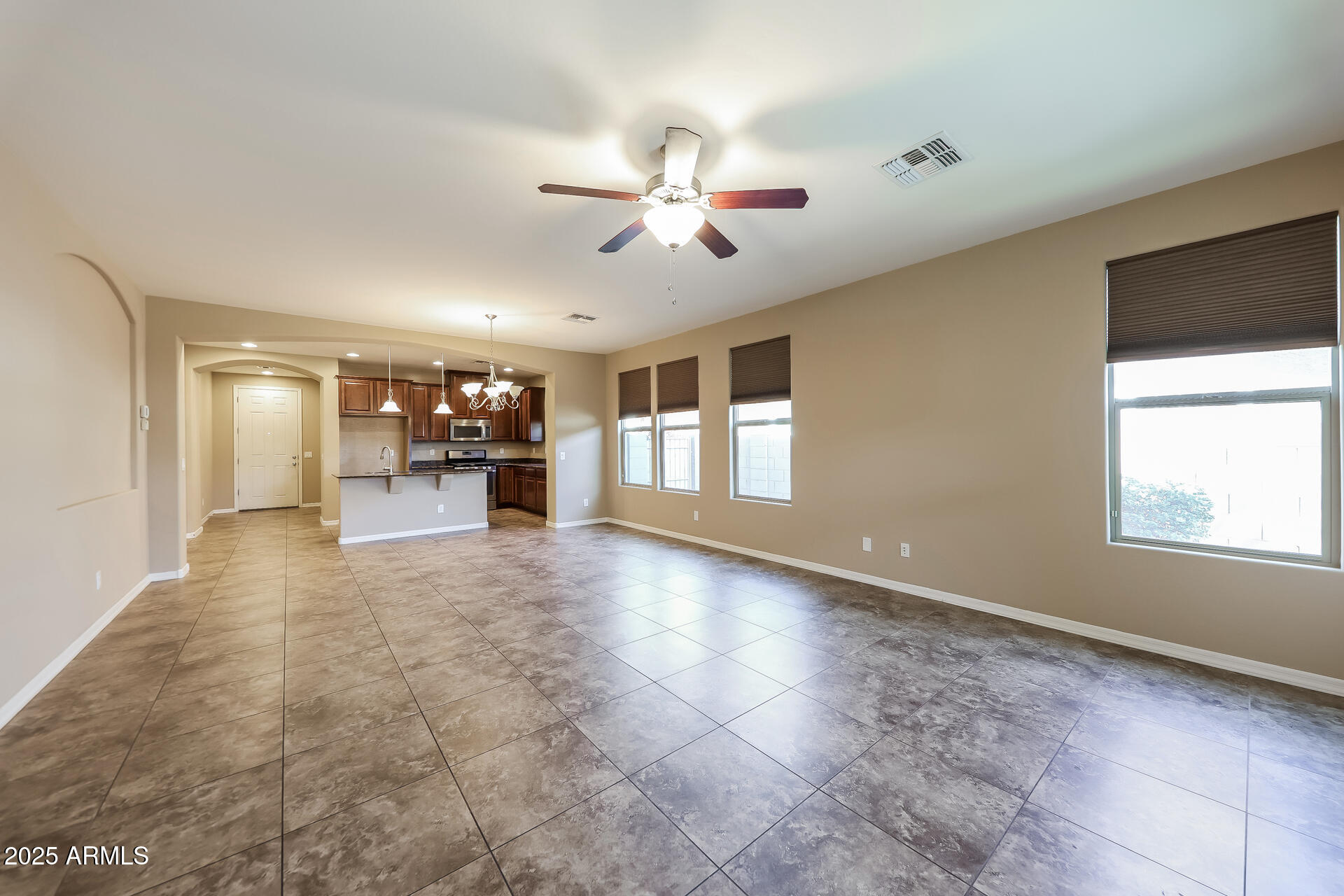 20693 West Ridge Road Buckeye, AZ 85396 - Photo 3 of 16 a view of a livingroom with a ceiling fan and window
