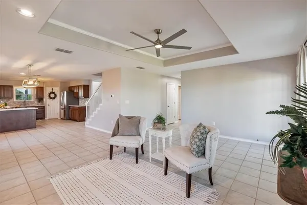 a living room with furniture and a potted plant