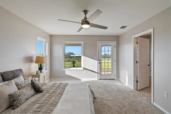 a spacious bedroom with a large bed and a balcony