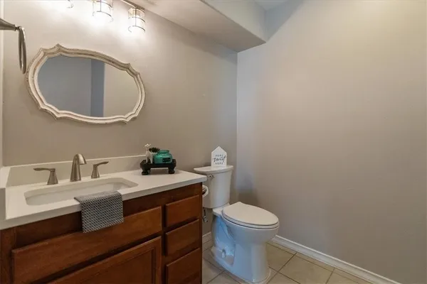 a bathroom with a toilet a sink and mirror