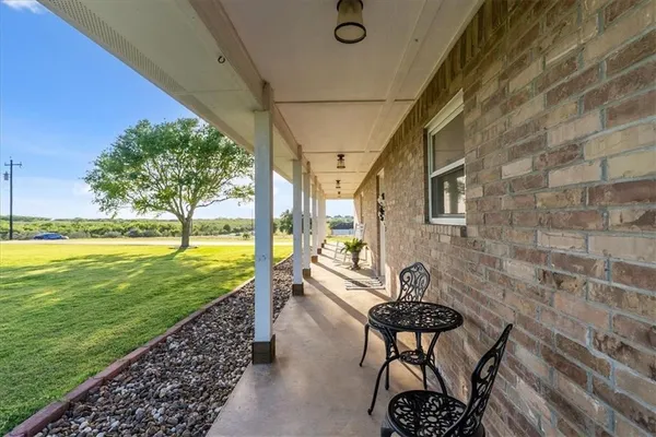 a view of a swimming pool with a table and chairs
