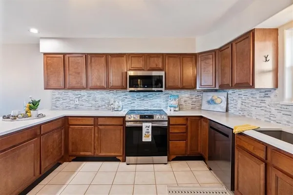 a kitchen with a sink cabinets and stainless steel appliances