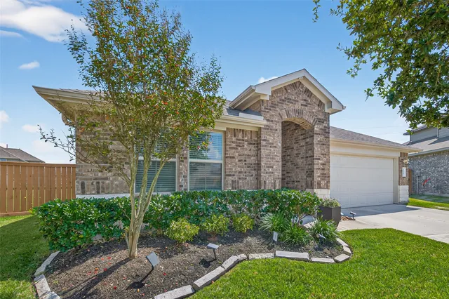 a front view of a house with a yard and outdoor seating