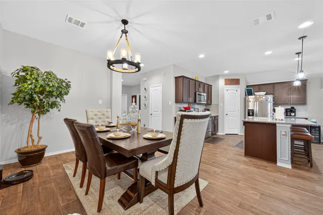 a view of a dining room with furniture window and wooden floor