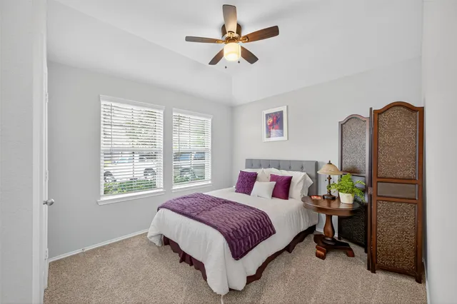 a bedroom with a bed dresser and a window