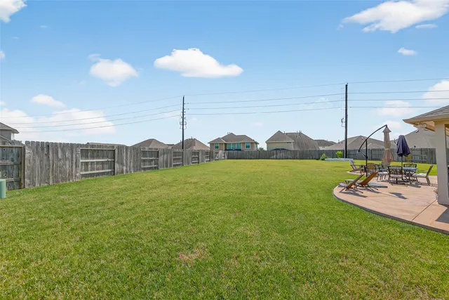a view of a house with a big yard and entertaining space