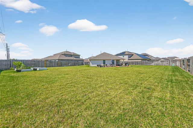 a view of a house with yard and balcony