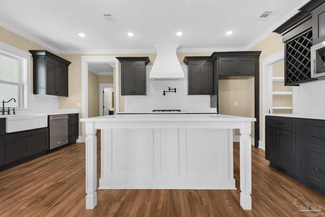 a large kitchen with stainless steel appliances kitchen island granite countertop a large counter top and sink