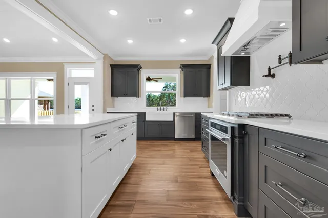 a view of walk in closet with wooden floor