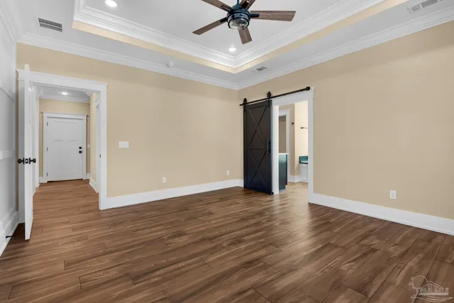 a view of a kitchen with a refrigerator and a stove top oven