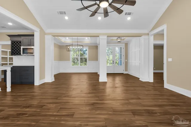 a view of a room with wooden floor and chandelier