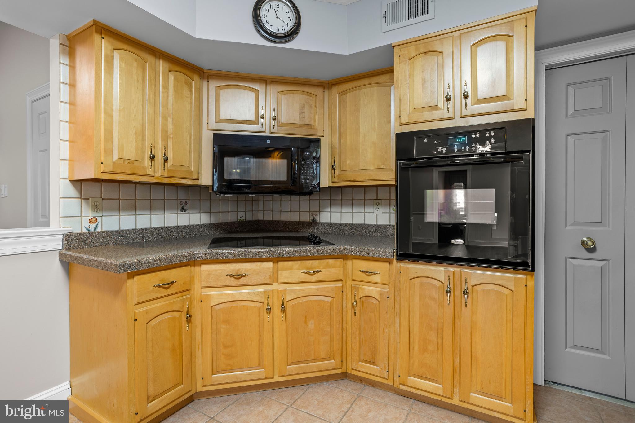 311 Ogden Place Springfield, PA 19064 - Photo 15 of 35 a kitchen with granite countertop a stove a sink and a microwave