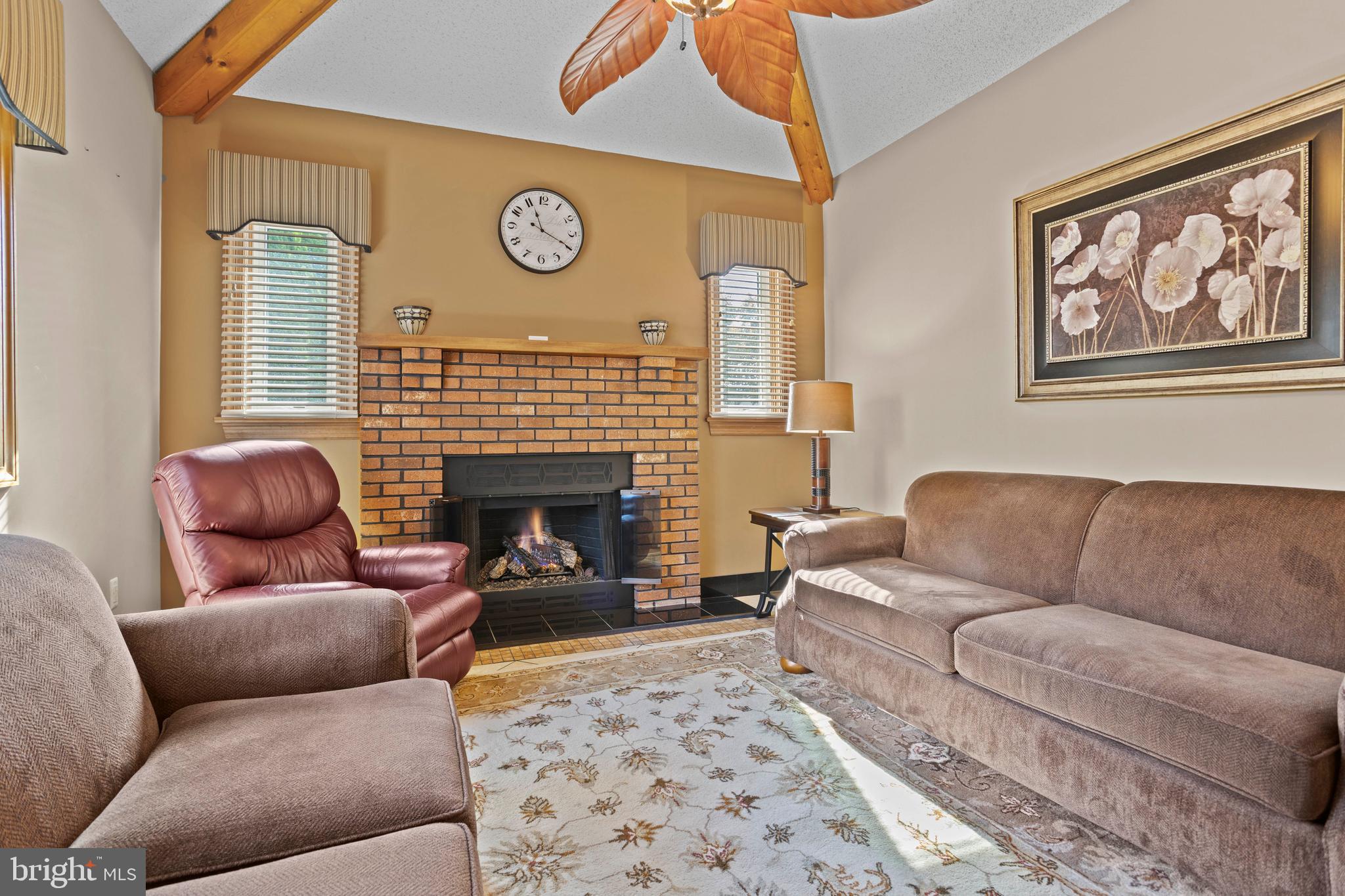 311 Ogden Place Springfield, PA 19064 - Photo 18 of 35 a living room with furniture a fireplace and window