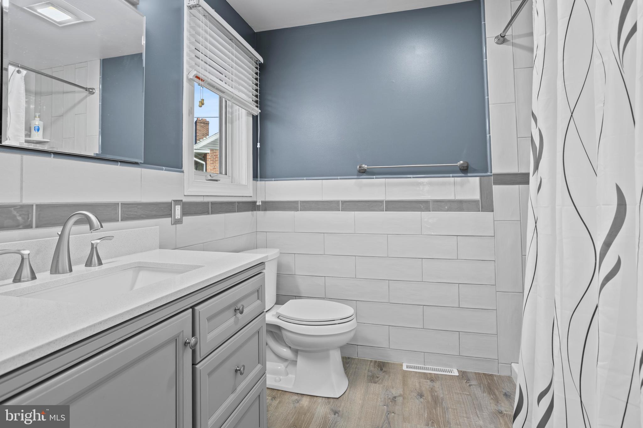 311 Ogden Place Springfield, PA 19064 - Photo 22 of 35 a bathroom with a toilet sink and mirror