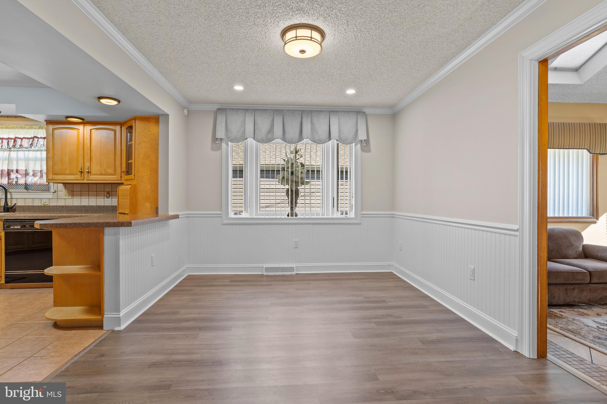 311 Ogden Place Springfield, PA 19064 - Photo 10 of 35 a view of a kitchen with a fridge and wooden floor