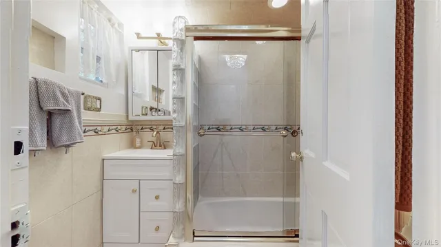 a bathroom with a shower sink and mirror