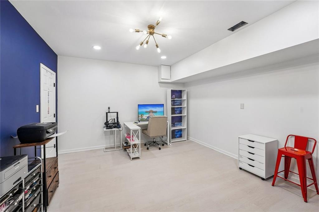 1091 Fieldstone Trail Milton, GA 30004 - Photo 60 of 84 a view of a workspace with furniture and a chandelier