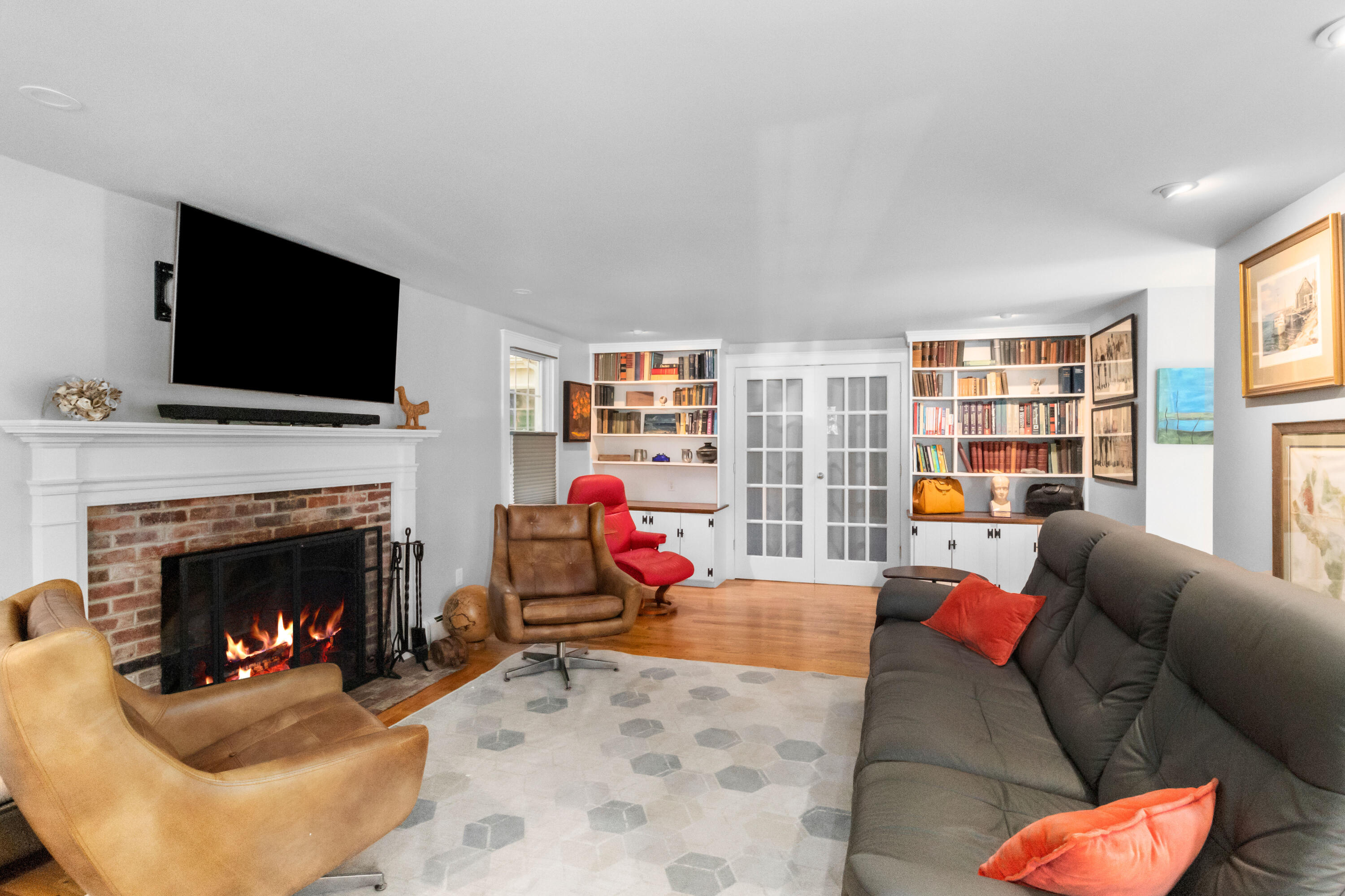 89 Namequoit Road Orleans, MA 02653 - Photo 11 of 42 a living room with furniture a fireplace and a flat screen tv