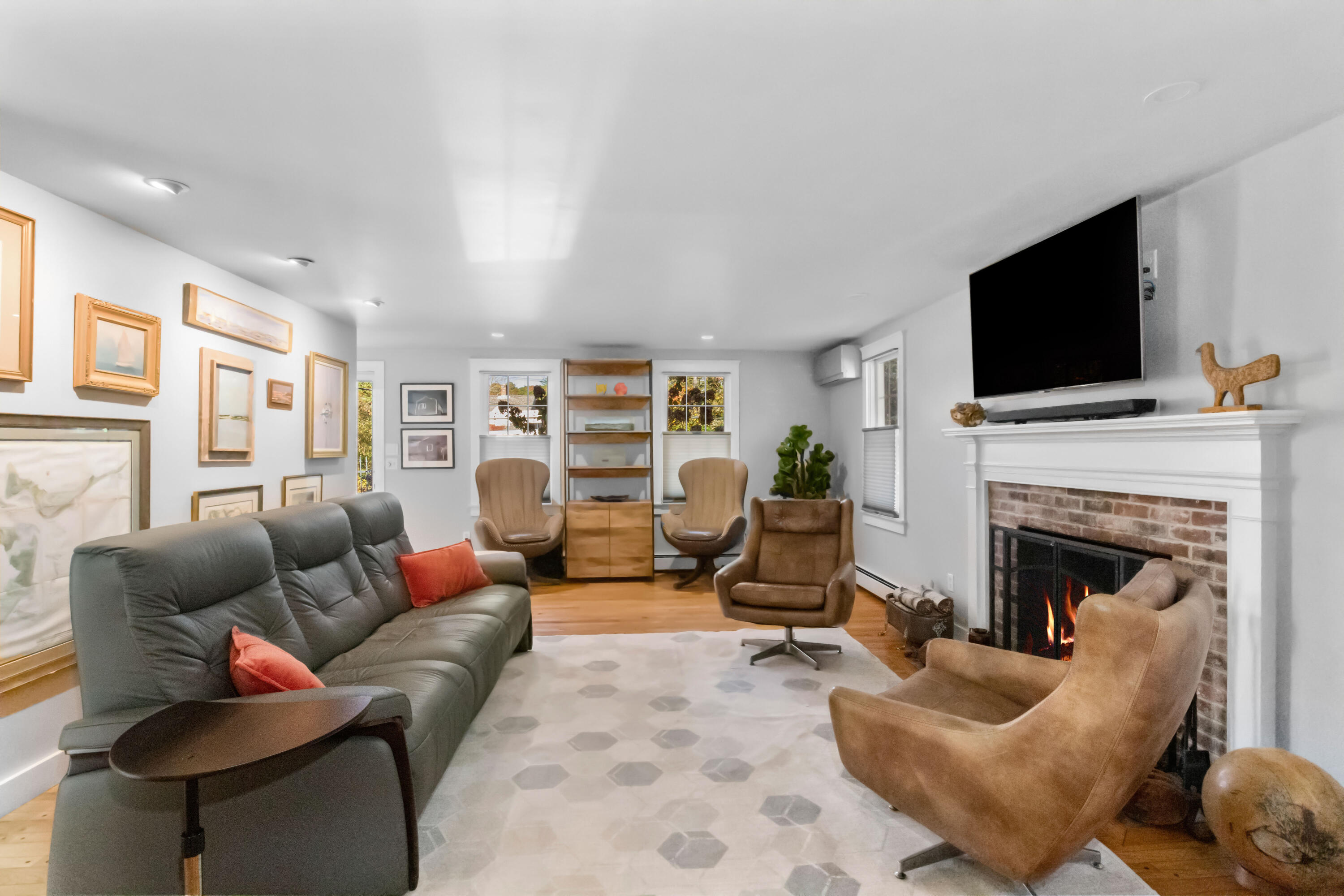 89 Namequoit Road Orleans, MA 02653 - Photo 12 of 42 a living room with furniture a flat screen tv and a fireplace