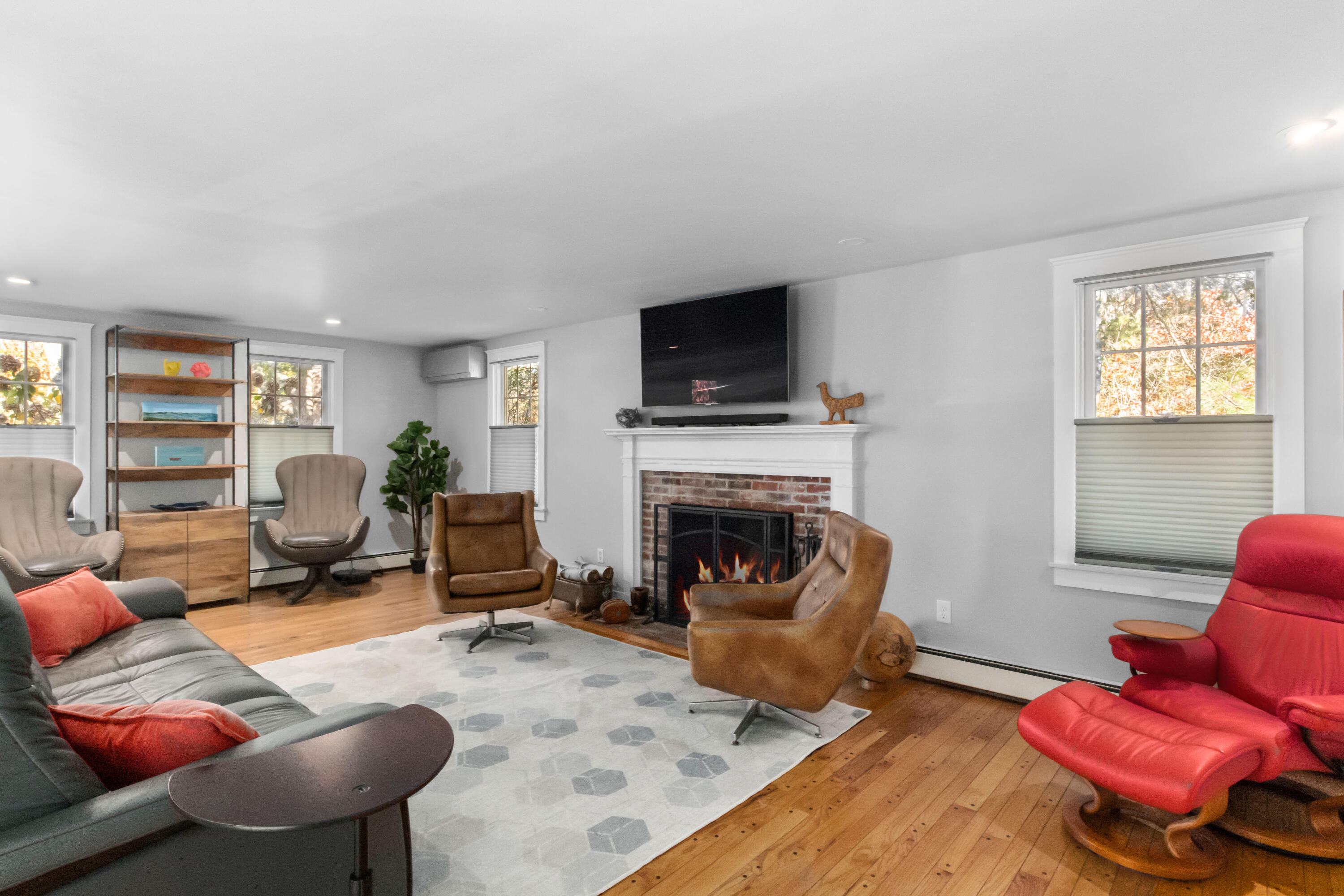 89 Namequoit Road Orleans, MA 02653 - Photo 13 of 42 a living room with furniture a flat screen tv and a fireplace