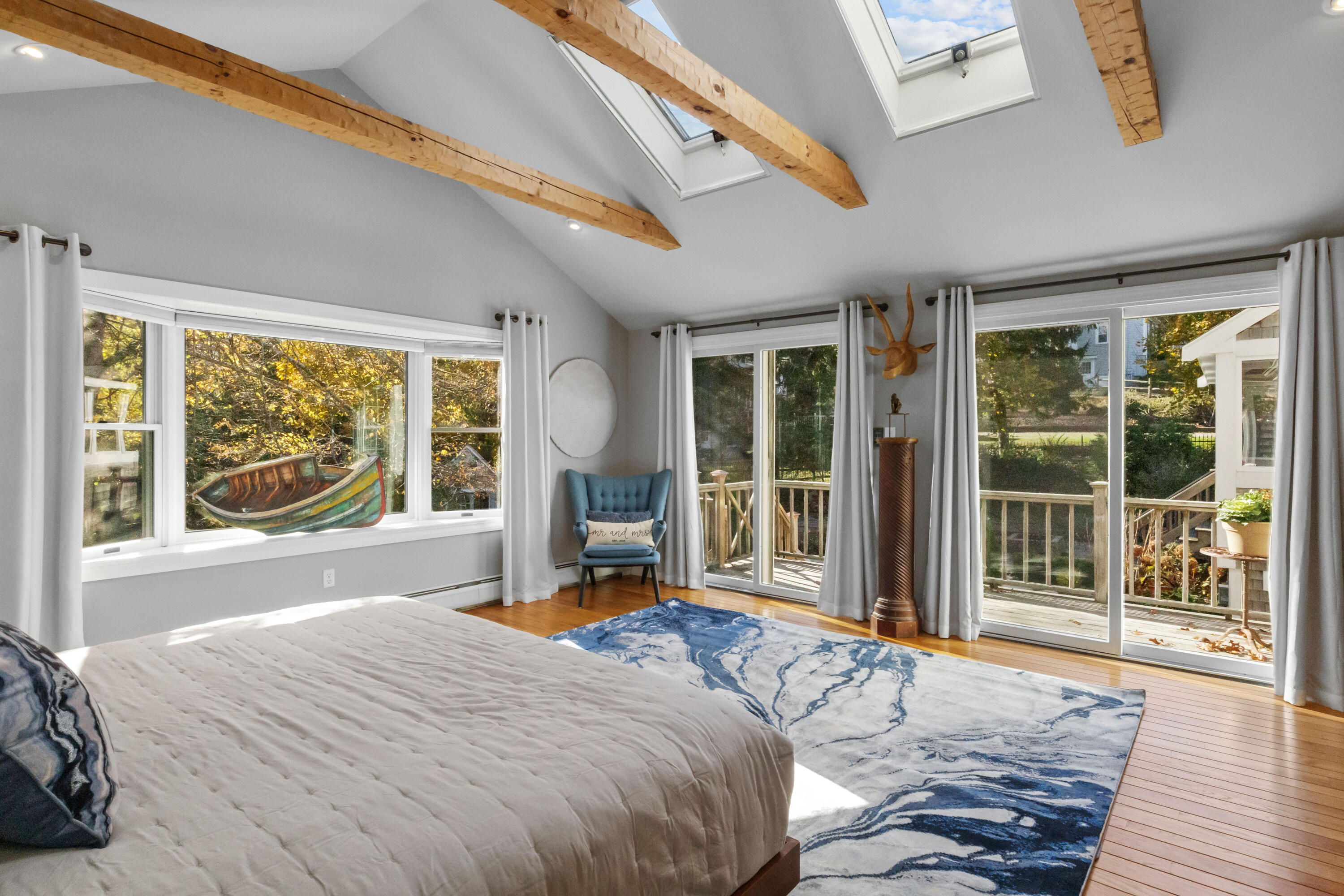 89 Namequoit Road Orleans, MA 02653 - Photo 15 of 42 a bedroom with a large bed and a large window