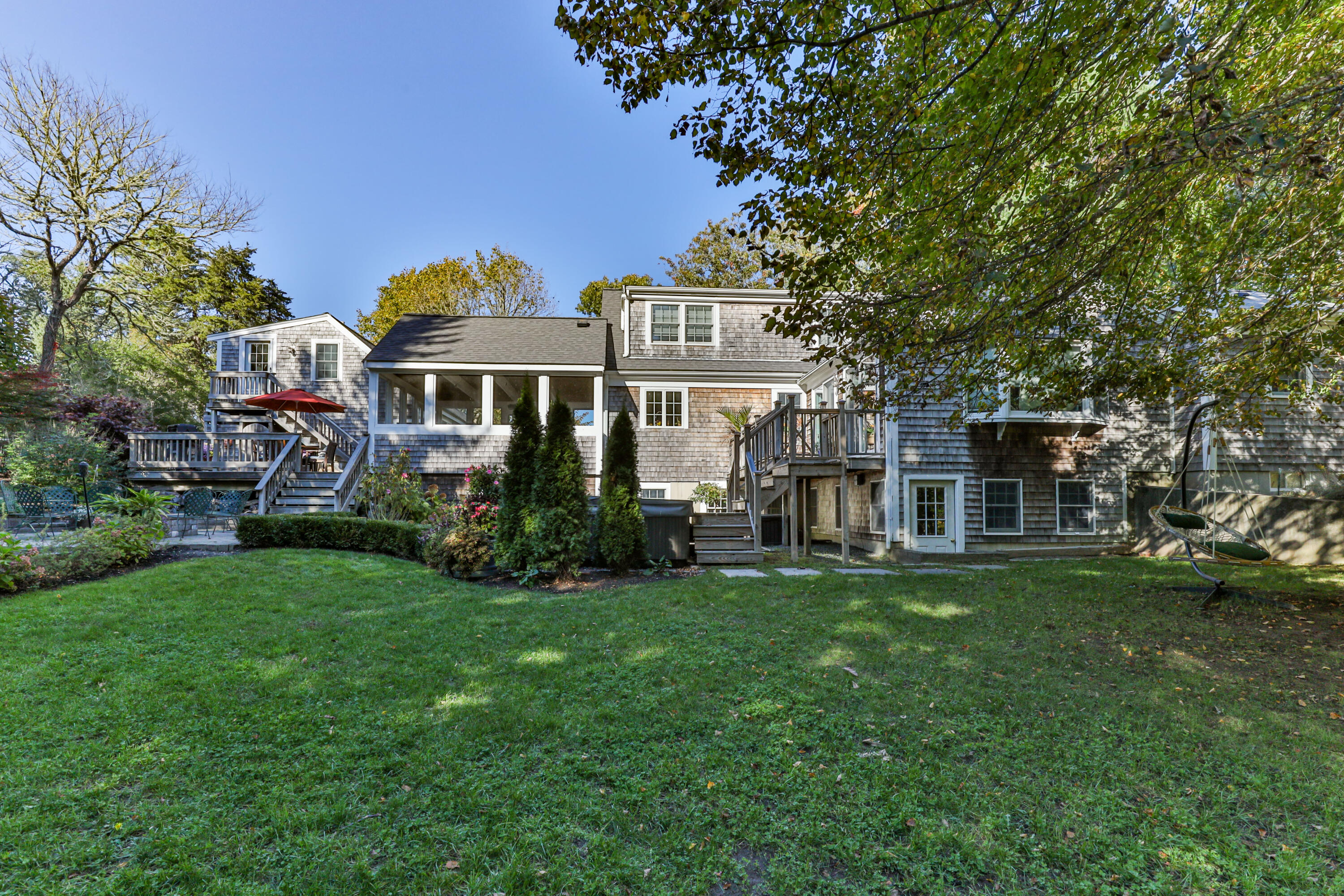 89 Namequoit Road Orleans, MA 02653 - Photo 40 of 42 a front view of a house with a garden