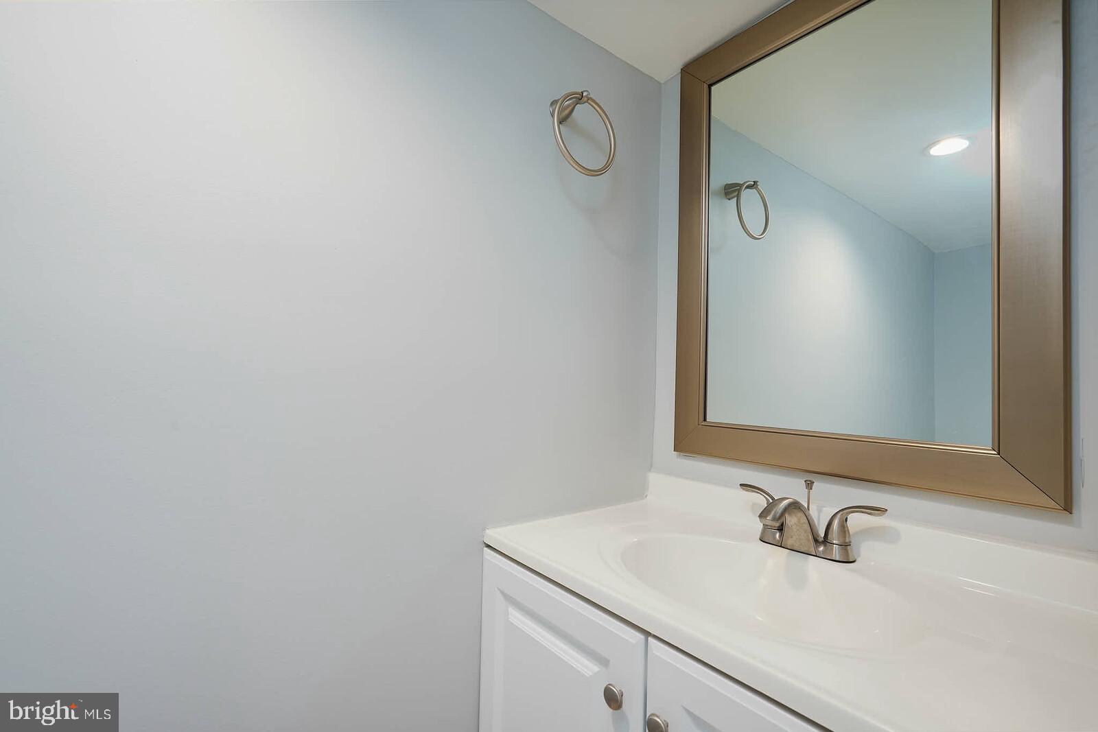 7719 Garrison Road Hyattsville, MD 20784 - Photo 16 of 23 a bathroom with a sink and a mirror