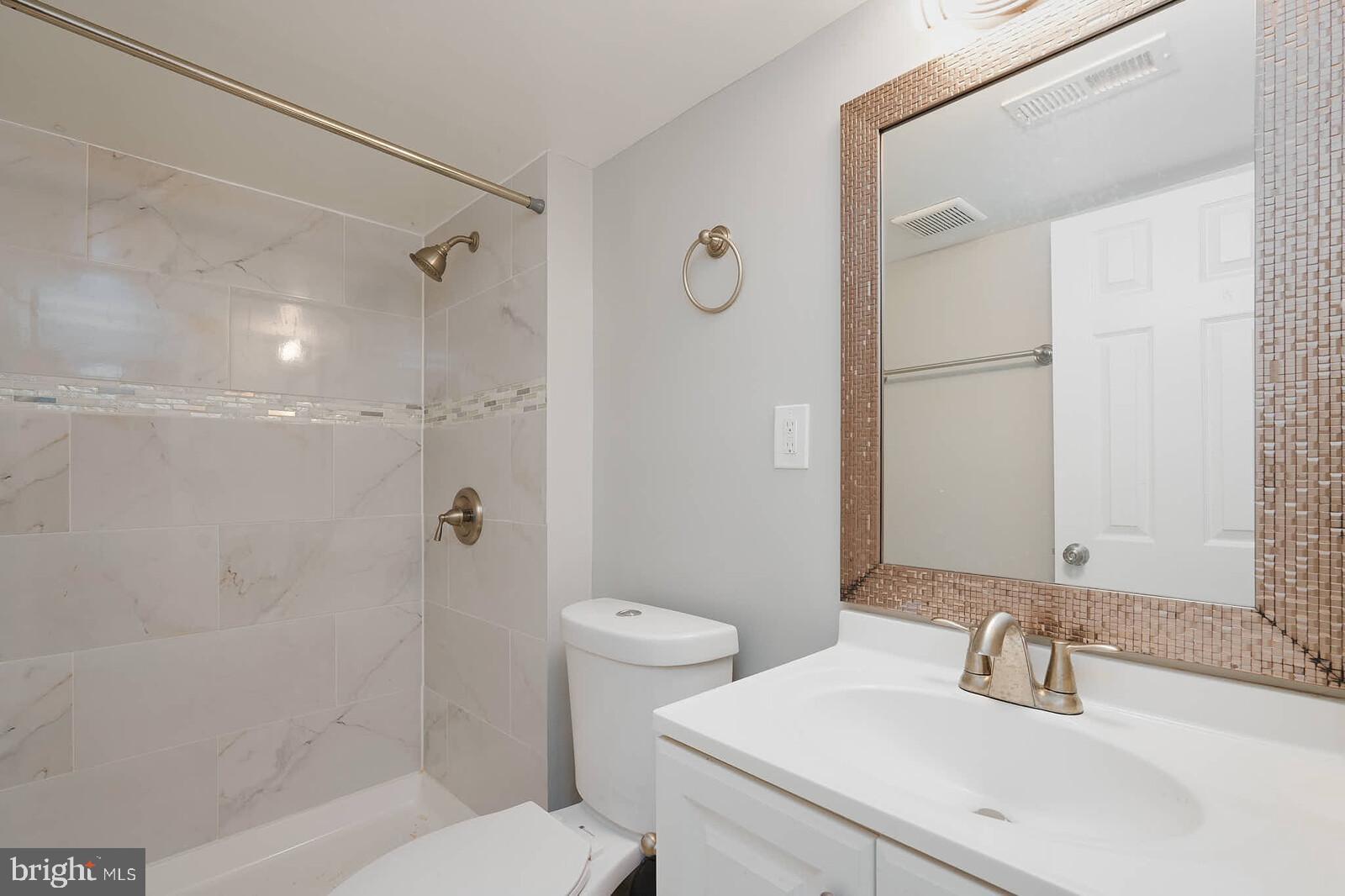 7719 Garrison Road Hyattsville, MD 20784 - Photo 19 of 23 a bathroom with a sink toilet and shower