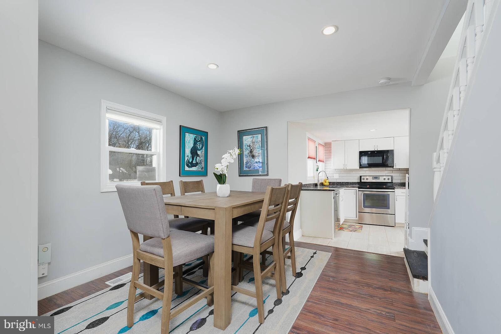 7719 Garrison Road Hyattsville, MD 20784 - Photo 3 of 23 a view of a dining room with furniture and wooden floor