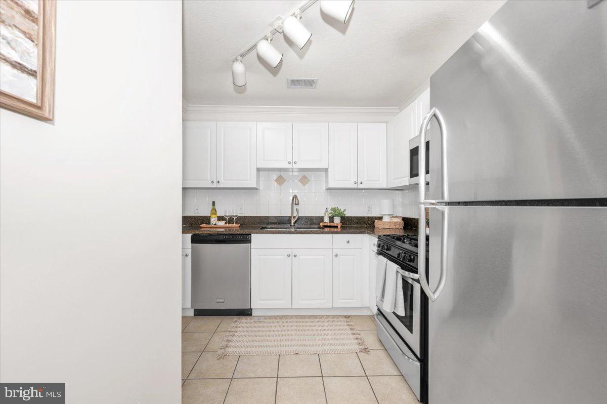 7 Booth Street, Unit 406 Gaithersburg, MD 20878 - Photo 24 of 117 a kitchen with a sink cabinets and stainless steel appliances