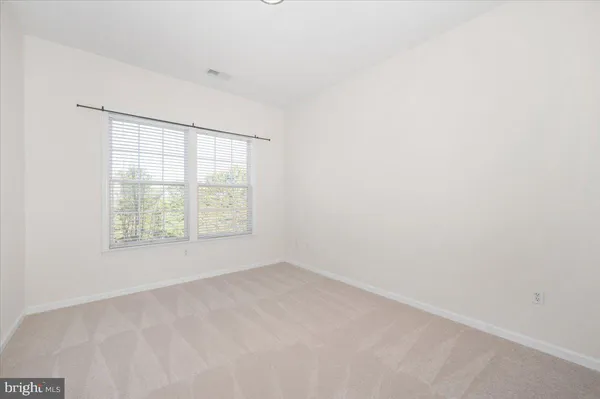 a view of a dining room with furniture large window and wooden floor