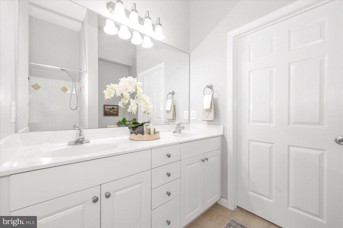 7 Booth Street, Unit 406 Gaithersburg, MD 20878 - Photo 33 of 117 a bathroom with a double vanity sink and a mirror