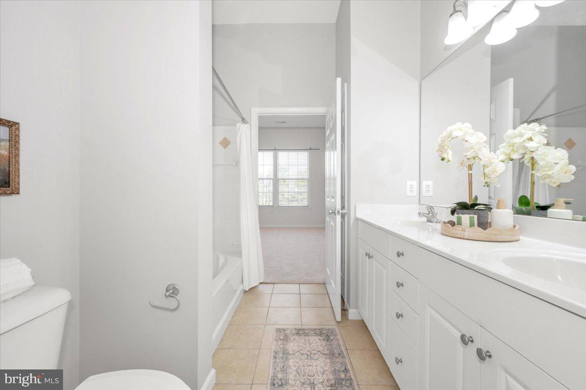 7 Booth Street, Unit 406 Gaithersburg, MD 20878 - Photo 34 of 117 a bathroom with a sink a toilet and a mirror