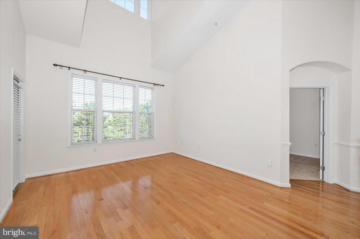 7 Booth Street, Unit 406 Gaithersburg, MD 20878 - Photo 4 of 117 an empty room with wooden floor and windows