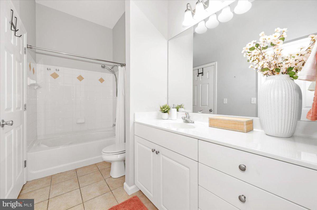 7 Booth Street, Unit 406 Gaithersburg, MD 20878 - Photo 40 of 117 a bathroom with a granite countertop sink a toilet and shower