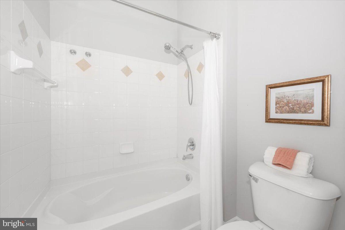7 Booth Street, Unit 406 Gaithersburg, MD 20878 - Photo 41 of 117 a white bath tub sitting next to a white toilet