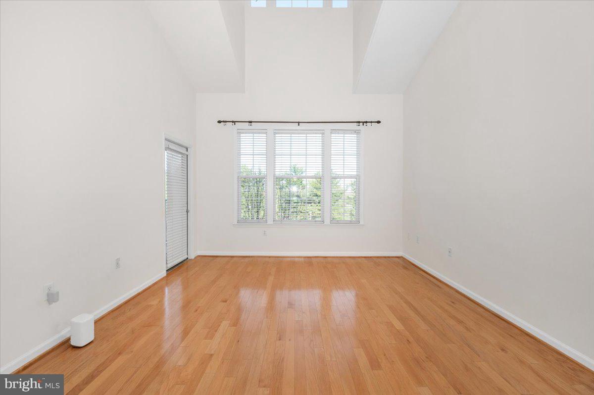 7 Booth Street, Unit 406 Gaithersburg, MD 20878 - Photo 5 of 117 an empty room with wooden floor and windows