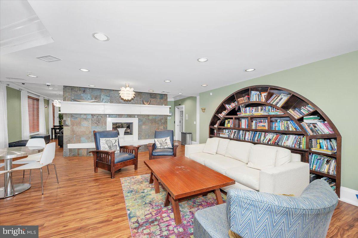 7 Booth Street, Unit 406 Gaithersburg, MD 20878 - Photo 52 of 117 a living room with furniture and a wooden floor