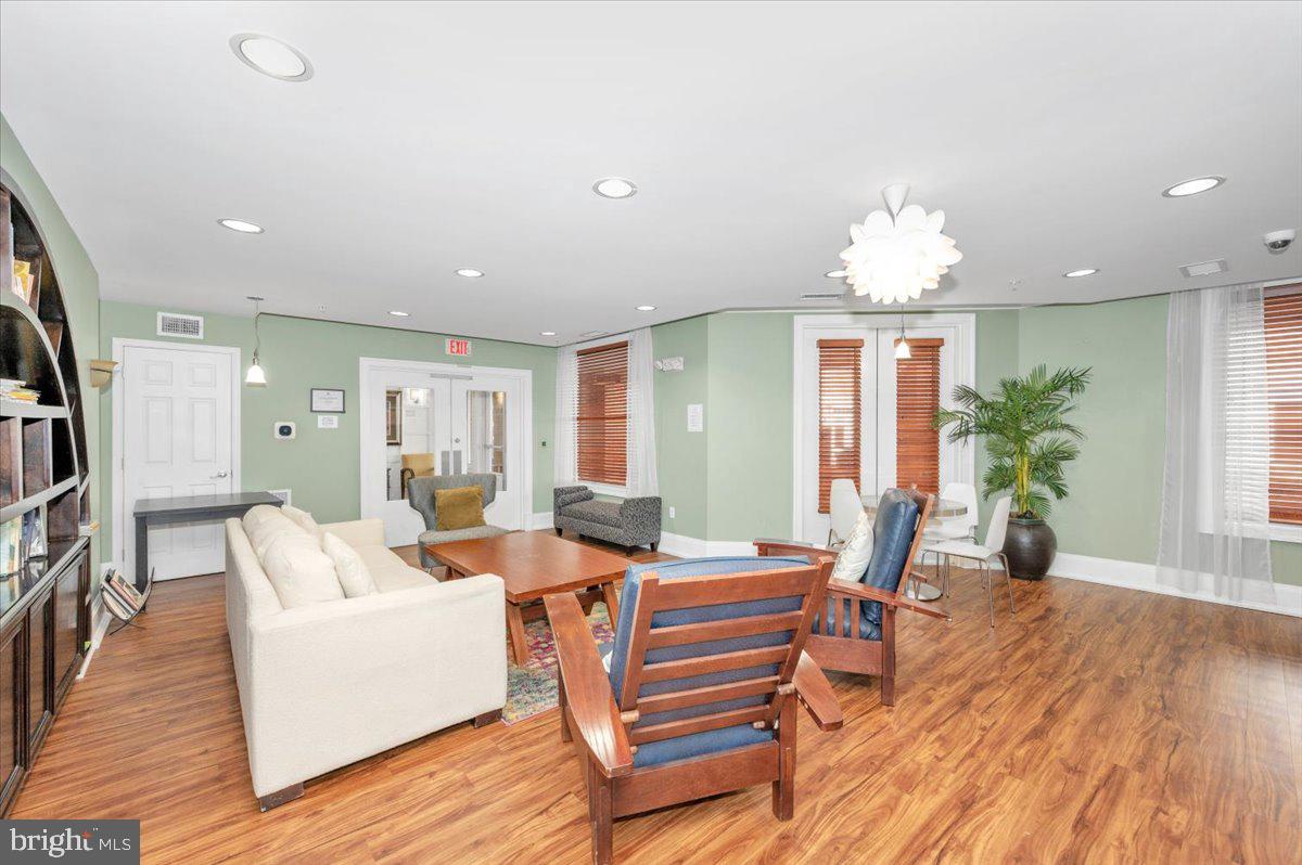 7 Booth Street, Unit 406 Gaithersburg, MD 20878 - Photo 55 of 117 a view of a dining room with furniture and wooden floor