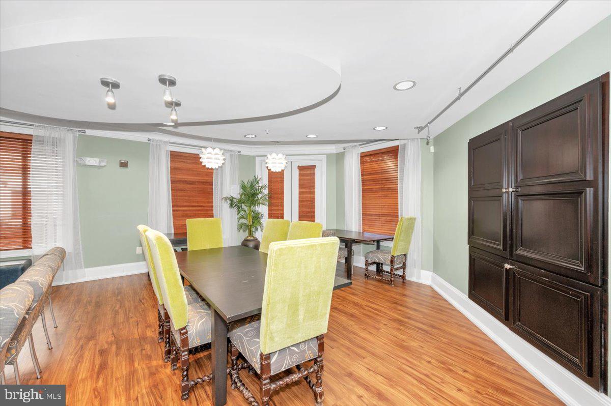 7 Booth Street, Unit 406 Gaithersburg, MD 20878 - Photo 58 of 117 a view of a dining room with furniture large window and wooden floor