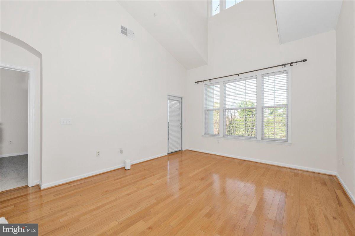 7 Booth Street, Unit 406 Gaithersburg, MD 20878 - Photo 6 of 117 an empty room with wooden floor and windows