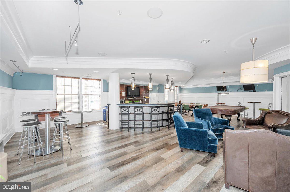 7 Booth Street, Unit 406 Gaithersburg, MD 20878 - Photo 60 of 117 a living room with lots of furniture and a chandelier