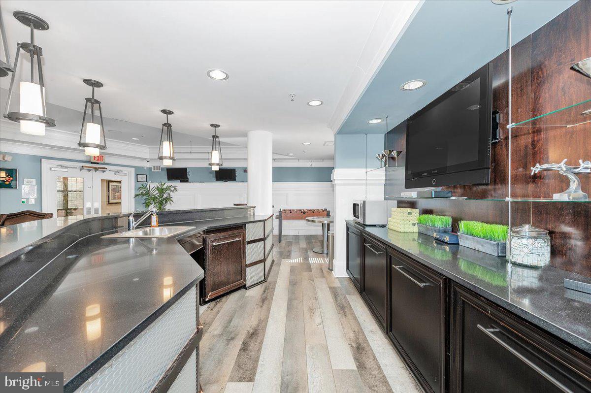7 Booth Street, Unit 406 Gaithersburg, MD 20878 - Photo 68 of 117 a large kitchen with stainless steel appliances granite countertop a lot of counter space and wooden floor