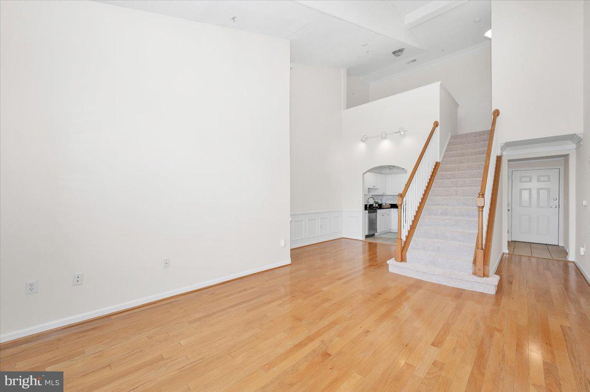 7 Booth Street, Unit 406 Gaithersburg, MD 20878 - Photo 116 of 117 a view of an empty room with wooden floor and stairs