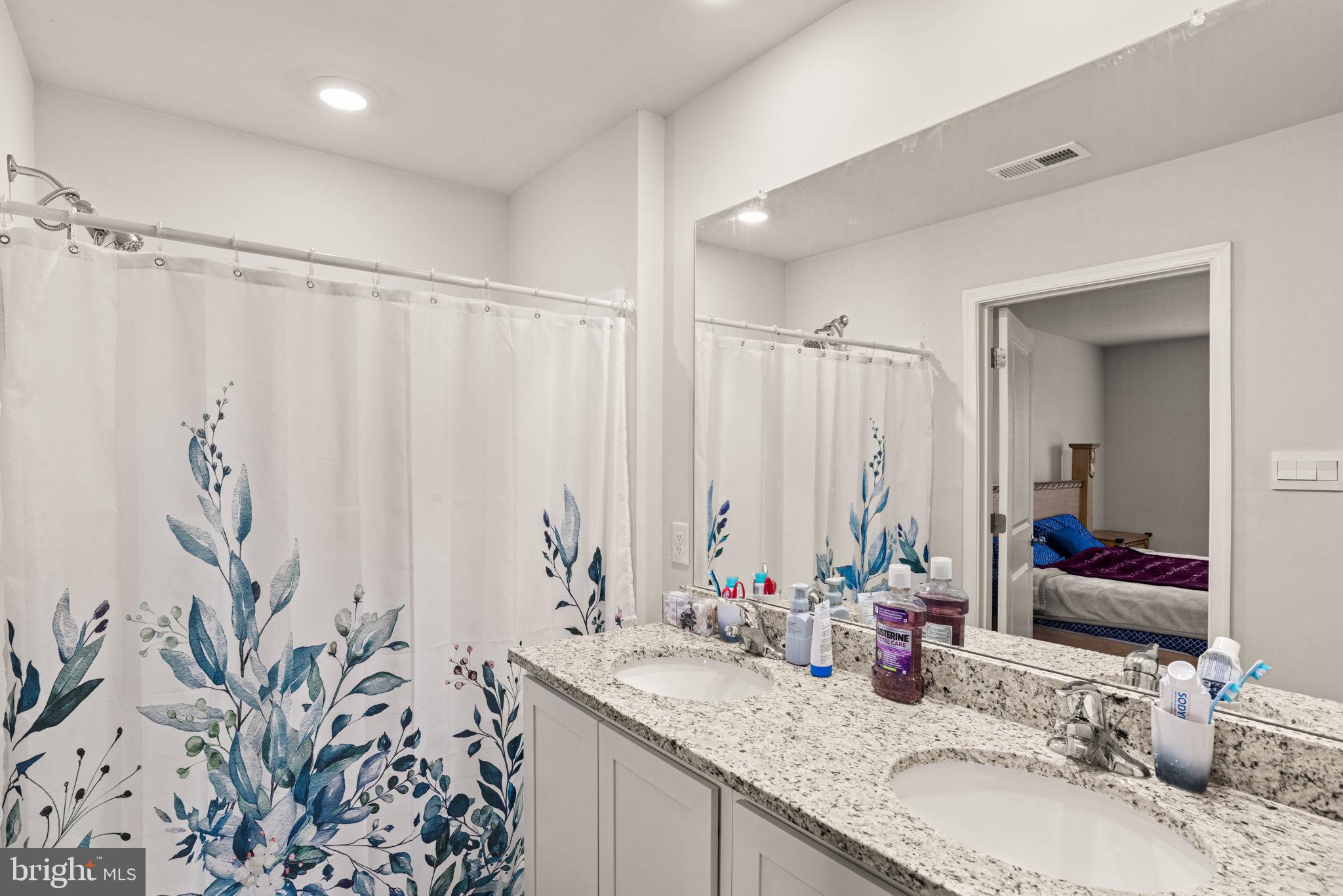 310 Maple Run Drive York, PA 17404 - Photo 17 of 28 a bathroom with a granite countertop sink a mirror and a shower curtain