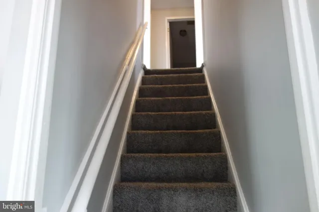 a view of staircase with white walls