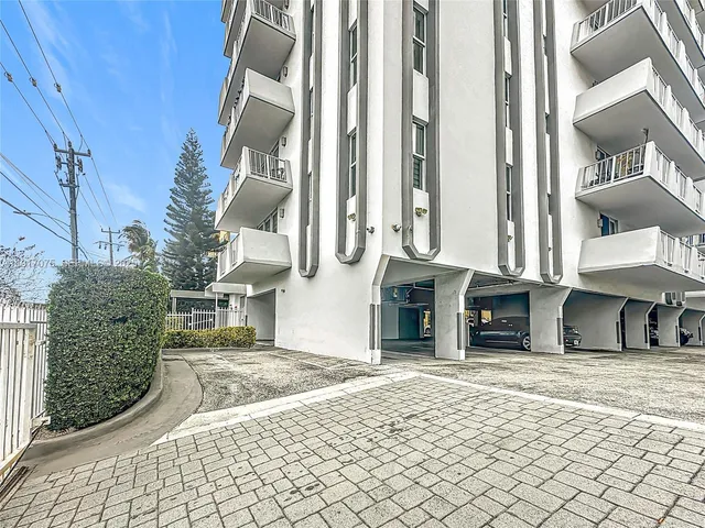 a view of a building with cars
