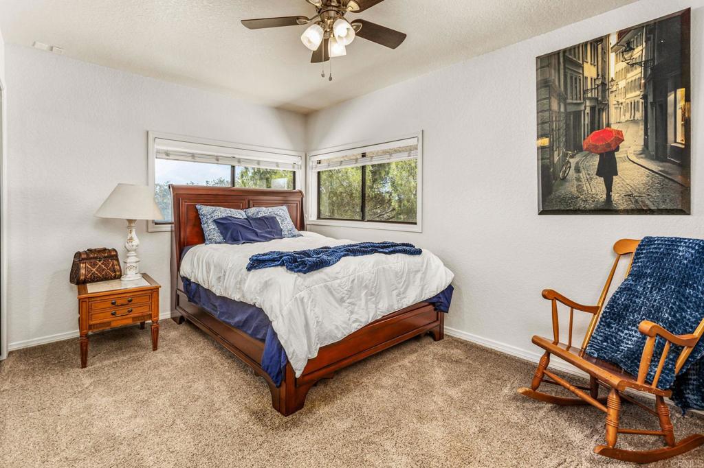 17901 Lyons Valley Road Jamul, CA 91935 - Photo 39 of 52 a bedroom with a bed and a chandelier